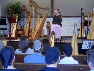 Joanna speaking to a group of harpists